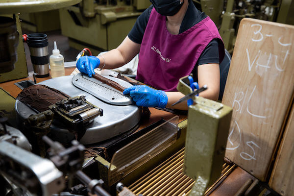 machine assisted cigar roller at the JC Newman Cigar Co factory in Ybor City, Tampa Florida