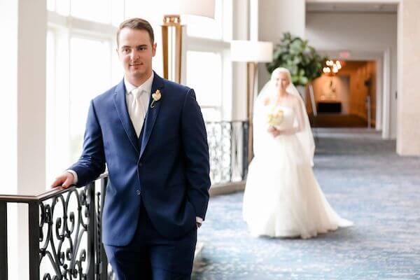 bride walking up behind her groom for their first look at the Marriott Water Street Tampa