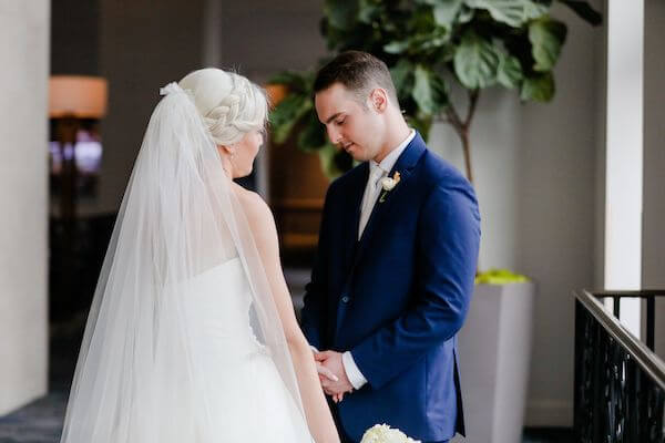 bride and groom holding hands after their first look