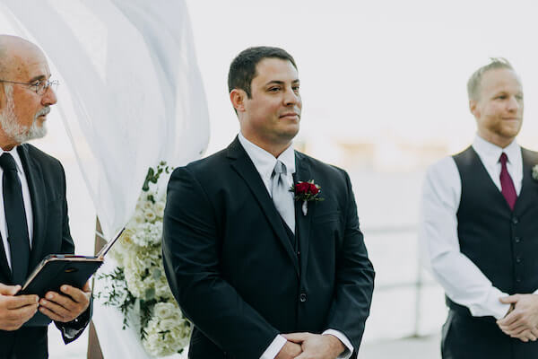 groom standing on the edge of the Boca Ciega Bay waiting for his bride's arrival