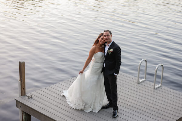 bride and groom posing for photos on their floating dock