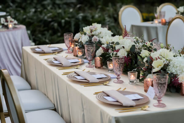 intimate wedding reception tables dressed in rose gold, pink and gold