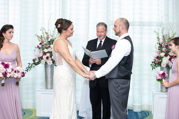 bride and groom exchanging wedding vows during their Opal Sands wedding ceremony