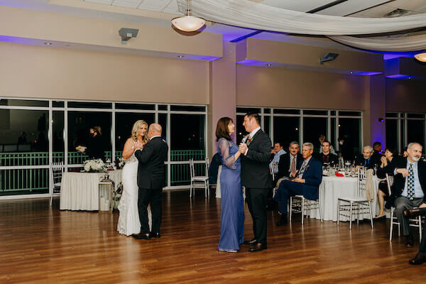 Bride and groom dancing with their parents at the St Pete beach Community Center on Boca Ciega Bay