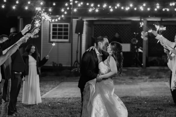 bride and groom kissing under a shower of sparklers