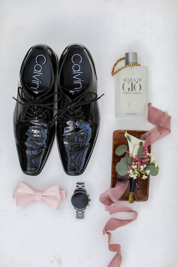 flat lay photo of groom wedding day accessories