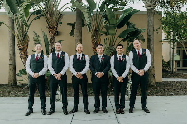 groom and wedding party taking photos at the st Pete beach community center on Boca Ciega bay