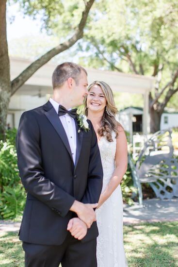 bride smiling as her groom to be sees her for the first time