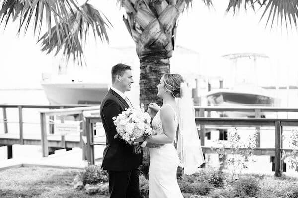 black and white photo of bride and grooms first look at Tampa Bay watch