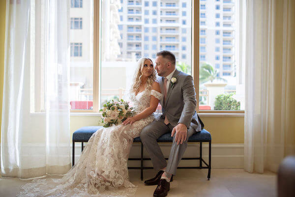 bride and groom snuggling on a bench