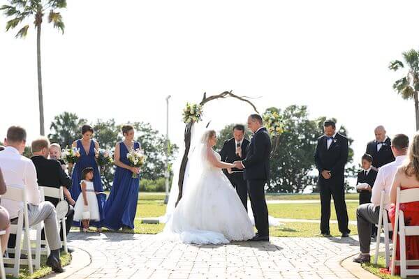 bride and groom exchanging wedding vows on the lawn at the Fenway Hotel in Dunedin Florida