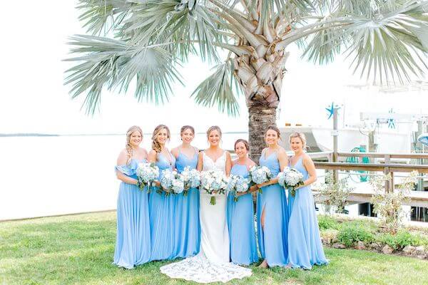 bride with her bridesmaids wearing blue at Tampa Bay Watch