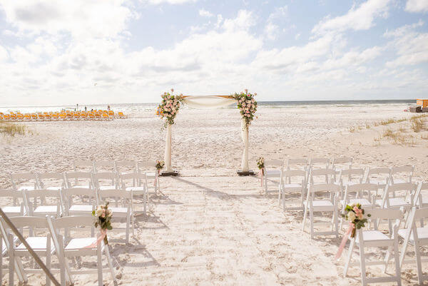 wedding structure with swags of pink and white flowers on clearwater beach