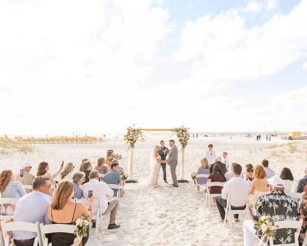 bride and groom exchanging wedding vows at their intimate CLEARWATER BEACH boho wedding