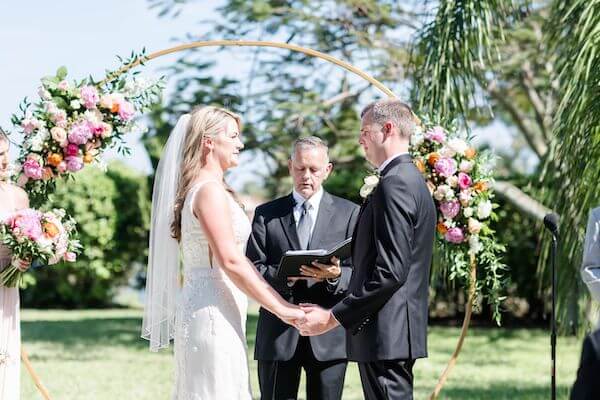 bride and groom exchanging wedding vows at their Tampa garden wedding