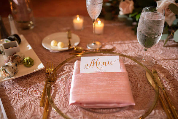 boho chic wedding reception mixing pink embroidered lace, gold flatware and pink silk napkin