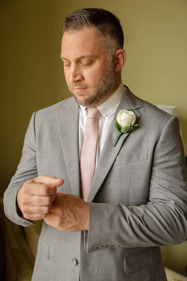 groom getting dressed on his wedding day