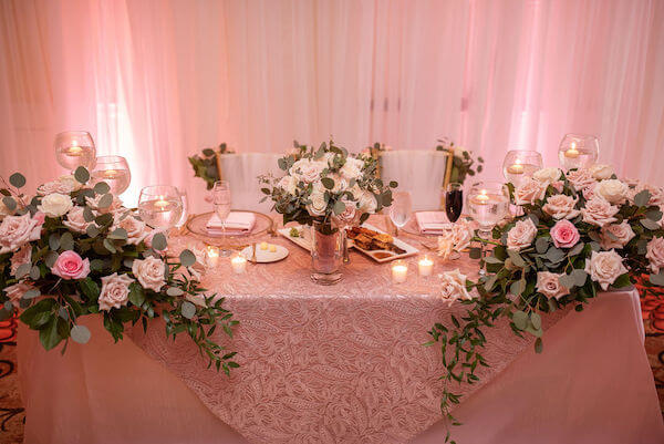 sweetheart table dressed in boho chic pink embroidered lace