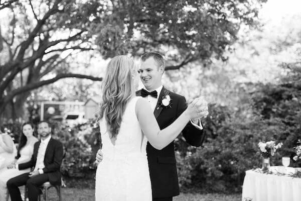 black and white photo of a couple's first dance in the garden