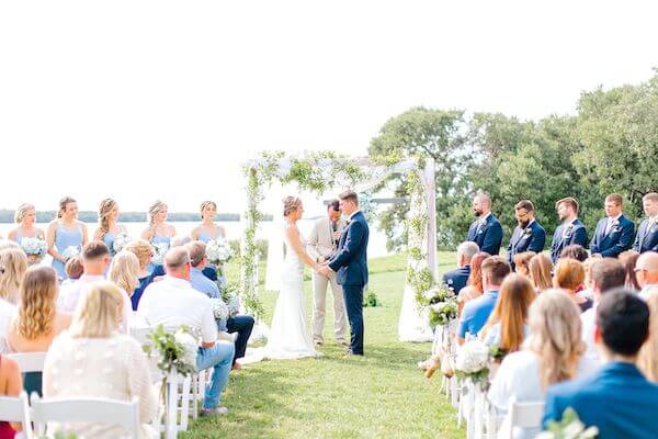 bride and groom exchange wedding rings at their Tampa Bay Watch wedding