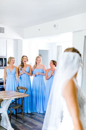 bridal party getting their first look at the bride in her wedding gown