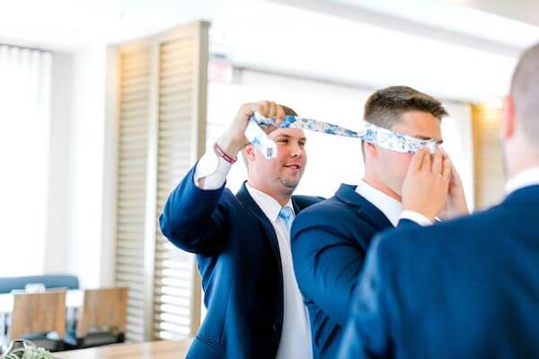 groomsmen blindfolding groom