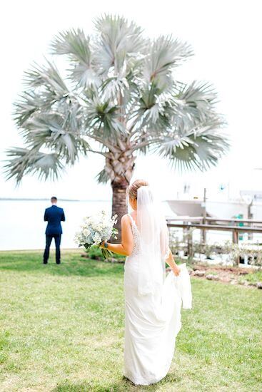 bride walking up behind her groom for their first look at Tampa Bay Watch