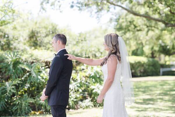 bride tapping groom on the should as they have their first look