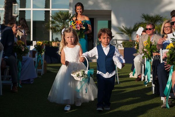 Ring bearer, flower girl and bridesmaid walking down the aisle at the Opal Sands Resort