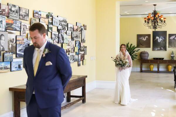 bride walking up behind her groom for a first look