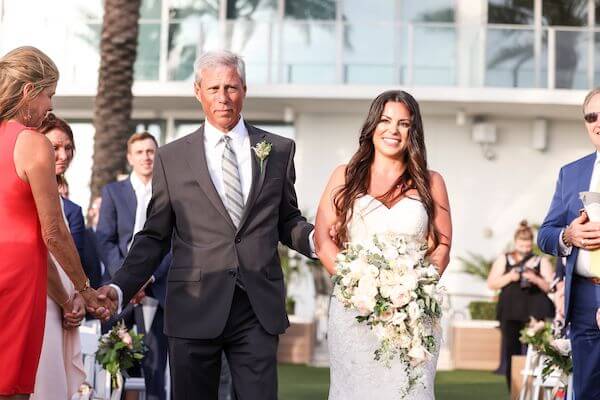 father of the bride escorting his daughter down the aisle at the Opal Sands Resort