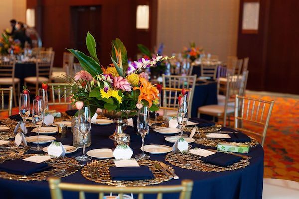 Opal Sands wedding reception with navy-blue linen and bright tropical colors