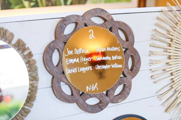 close up of a rustic seating chart made by bride and father