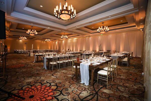 SandPearl Resort ballroom set with soft neutrals and wooden farmhouse tables