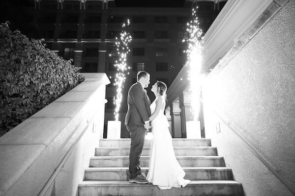 bride and groom in front of a sparkler fountain