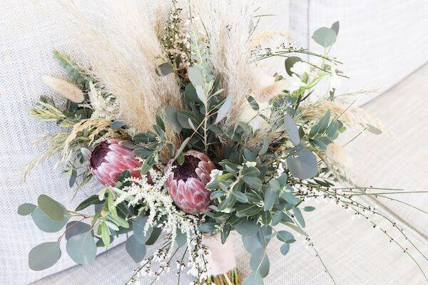 bridal bouquet with greenery, sea grass and proteas