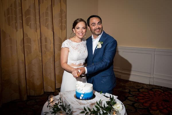 bride and groom cutting an intimate blue and white ombre wedding cake