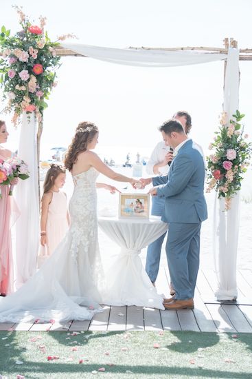 bride and groom during sand during a sand ceremony at the beach wedding