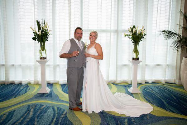 Happy bride and groom toasting with champagne after their wedding ceremony