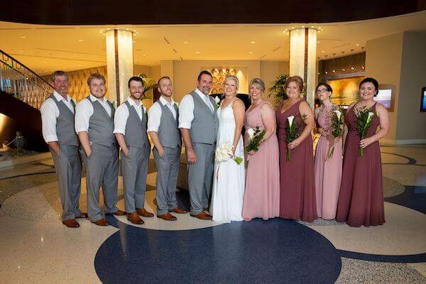 Newlyweds and their wedding party taking photos inside the Opal Sands Resort