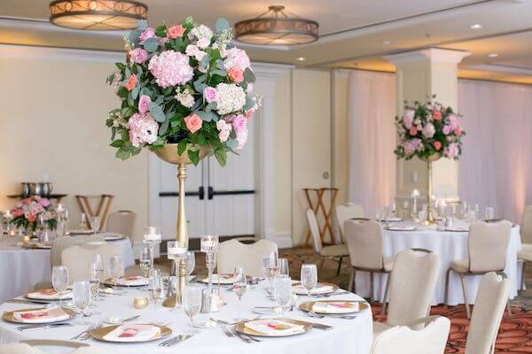 pink floral centerpieces on gold risers at a clearwater Beach wedding reception