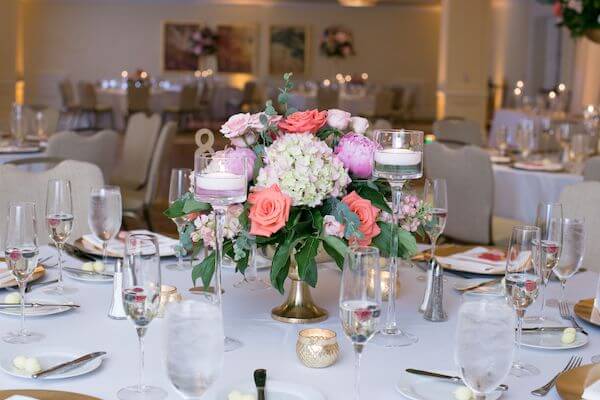 pink floral centerpieces on gold risers at a clearwater Beach wedding reception