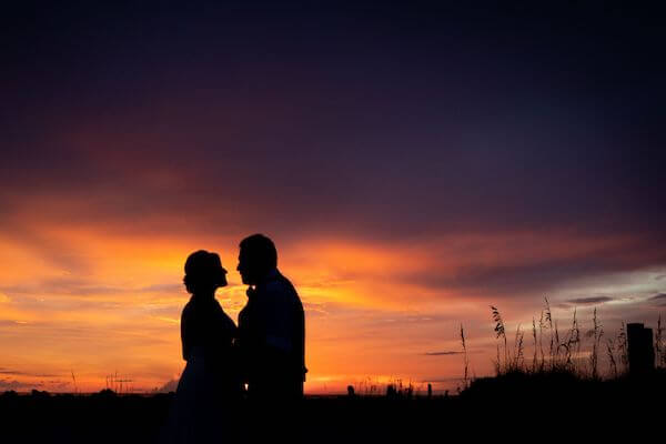 silhouette of a bride and groom at sunset on Clearwater Beach