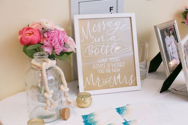 a couple chose a message in a bottle instead of a guest book for their beach themed wedding