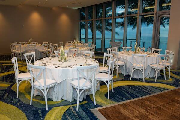 Opal Sands Resort ballroom set with white linen and calla lilies