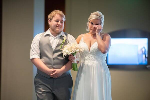 Bride breaks into teas as she walks down the aisle