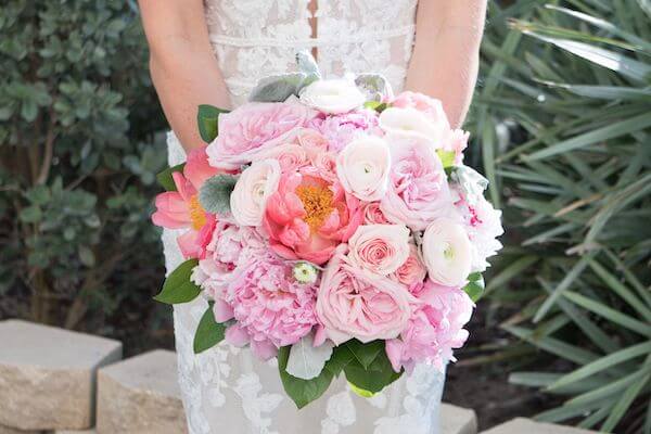 Pink bridal bouquet with peonies, roses and ranunculus 