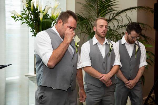 groom overwhelmed seeing his bride starting to cry