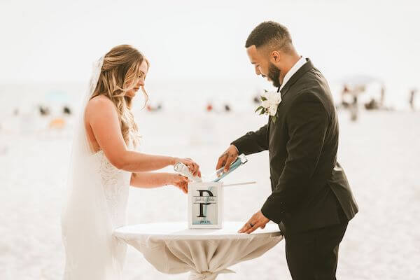 couple pouring sand during their Sand Ceremony at their Clearwater Beach wedding