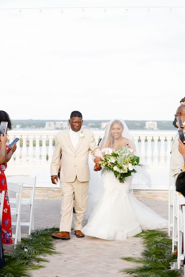 bride being escorted down the aisle by her father on the Sky Terrace at the Hyatt Regency Clearwater Beach